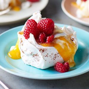 Star anise meringues with mango coulis & raspberries image