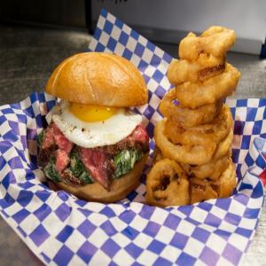 Steak and Egg Sandwich with Creamed Spinach and Onion Rings_image