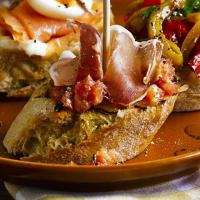 Spanish ham with crusty bread & chopped tomato image