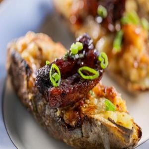 Twice-Baked Potatoes with Crispy Pork Belly and Cheddar Cheese image