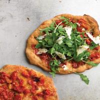 Individual Pizzas with Pecorino, Arugula, and Tomatoes image