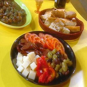 Crusty Bread, Sliced Tomatoes with Lemon, Sliced Pimentos, Spanish Cheese and Olives image