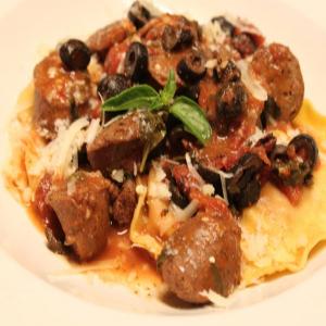 Black olive sauced chicken sausage with red pepper and tomato ravioli_image