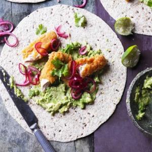 Smashed avocado with crispy chicken, pickled onions & tortillas image