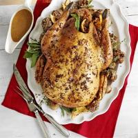 Roast turkey with pecan, sausage & chestnut stuffing & roast shallots image