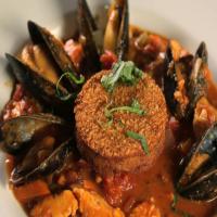 Pacific NW Cioppino with Rockfish, Salmon, Mussels and Dungeness Crab Cake image