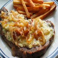 Pub Style Peppered Stilton Steaks With Charred Onions and Chips image