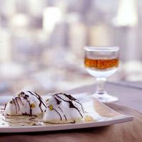 Snow Eggs with Pistachio Custard and Chocolate Drizzle image