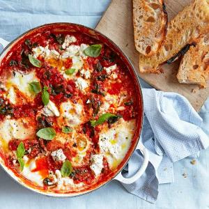 Baked eggs with spinach, tomatoes, ricotta & basil image