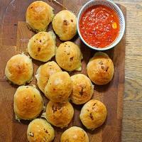 Cheese-stuffed garlic dough balls with a tomato sauce dip image