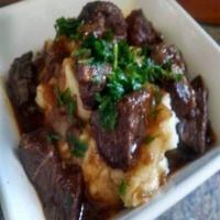 Red Wine and Demi Glace Roast Beef over potatoes_image