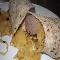 Beer-Bathed Brats With Sauerkraut and Apples image