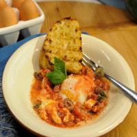 Baked Eggs with Salami, Mozzarella, Olives and Garlic Bread image