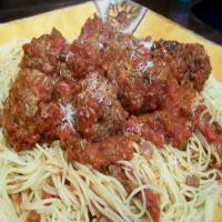 That's a Spicy Meatball Parmesan over Spaghetti_image