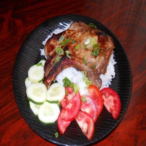Asian marinated pork chops over a bed of jasmine rice_image