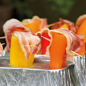Mini Peppers Stuffed With Cheese and Topped With Bacon - Grilled image