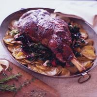 Roast Leg of Lamb on a Bed of Potatoes and Wilted Greens image