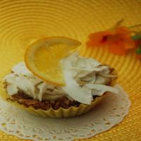 Lemon Pudding Filled Coconut Cupcakes with Shaved Coconut Topping image