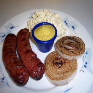 Brats With Glazed Red Onions image