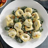 Ricotta and Spinach Tortelloni with Creamy Parmigiano Sauce, Kale and Pine Nuts image
