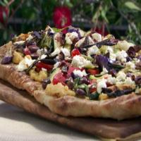 Grilled Pizza with Spicy Hummus, Vegetables, Goat Cheese and Black Olives image