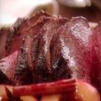 Leg of Venison with Cider-Baked Apples, Red Chard, and Cranberry Sauce image