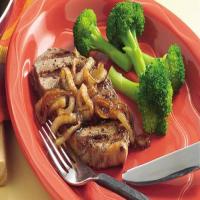 Pepper-Rubbed Grilled Steaks with Caramelized Onions image