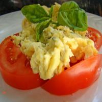 Scrambled Eggs over Fresh Sliced Tomatoes and Basil image