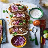 Slow-cooked chicken tinga tacos with pickled onions_image