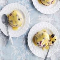 Little blueberry puddings with lemon curd sauce image