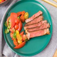 Braai-Rubbed Rib-Eye Steaks with Tomato Salad image