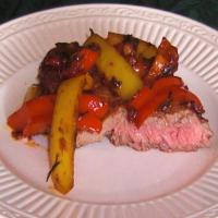 Steak Topped With Peppers and Onions_image