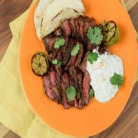 Hanger Steak Tacos with Cilantro-Lime Crema and Charred Limes image