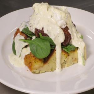 Savory Bread Pudding with Sausage, Spinach, Poached Eggs, and Parmesan-Thyme Cream image
