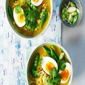 Golden noodle soup with soft-boiled eggs image