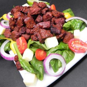 Churrasco on a Bed of Baby Spinach Tossed in Lime Dressing_image