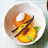 Poached peaches in sparkling wine with basil & vanilla image