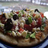 Pita Pizzas With Hummus, Spinach, Olives, Tomatoes & Cheese image