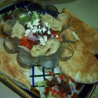 Grilled Chicken, Greek-Style, With Salad and Warm Pita Bread For image