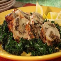 Stuffed Pork Tenderloin Over Grilled Kale Drizzled with Grilled Peach Whiskey Beurre Blanc image