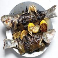 Whole Branzino in Grape Leaves with Zucchini, Olives, and Mint image