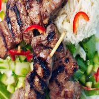 Teriyaki steak skewers with chopped green salad_image