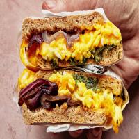 Breakfast Sandwich on an English Muffin With Charred Red Onions, Herbs, and Cheddar image