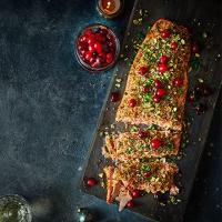 Baked salmon fillet with pickled cranberries, parsley & pistachios image
