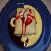 Three Berry Crepes with Creme Anglaise and Strawberry Sauce_image