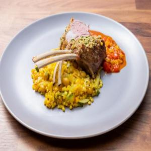 Herb Crusted Rack of Lamb with Harissa Sauce and Saffron Israeli Couscous with Zucchini and Fennel image