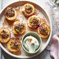 Roast pistachio-stuffed peaches with orange blossom cream image