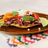 Chicken Tomatillo Tostadas with Refried Black Beans and Cabbage-Pepper Slaw image
