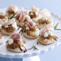 Pizzettes with Caramelized Onions, Goat Cheese, and Prosciutto image