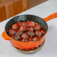 Chorizo Stuffed Dates Wrapped in Bacon in Red Pepper Sauce image